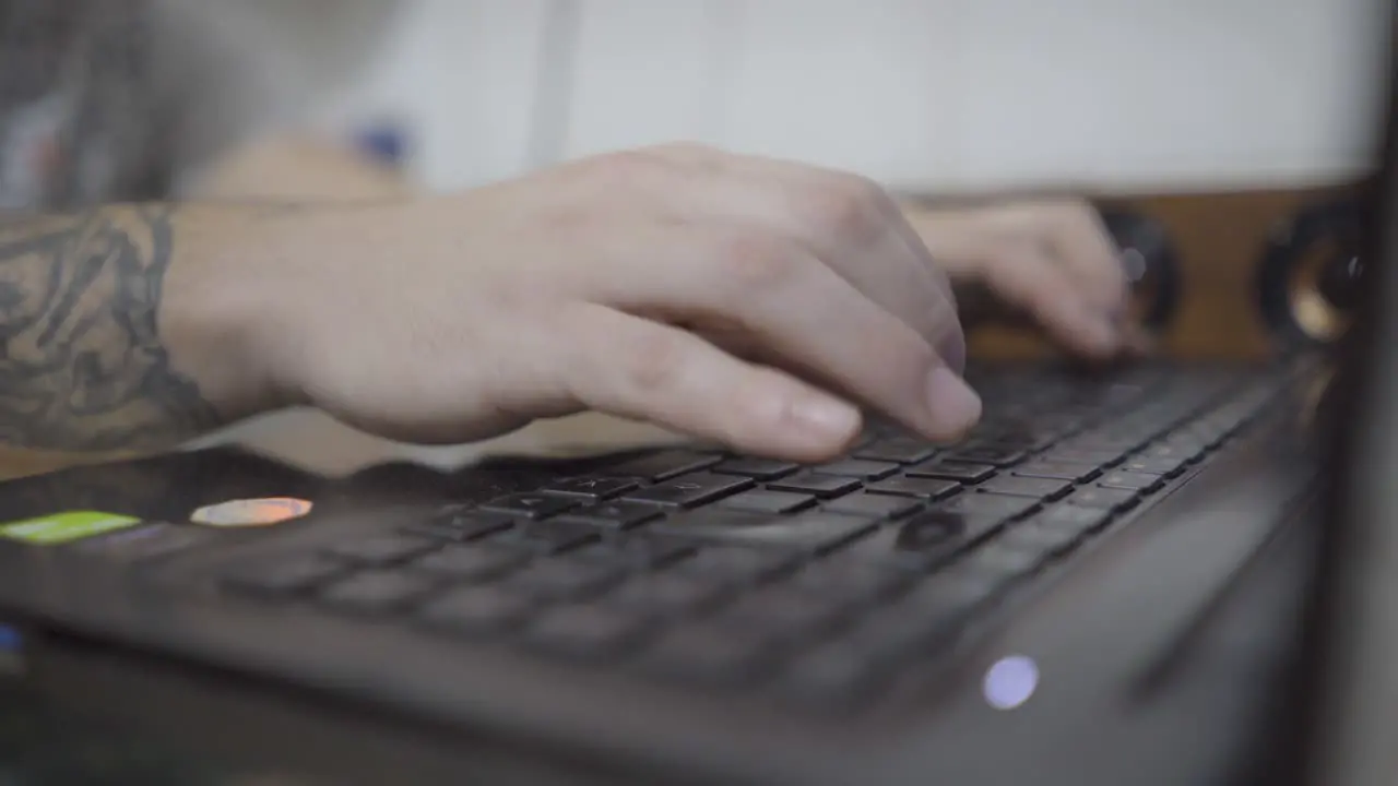 Close up hand typing on a laptop keyboard