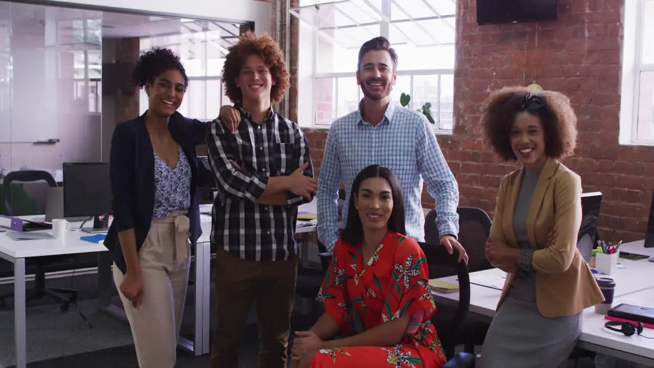 Group of diverse business colleagues smiling at camera in office room