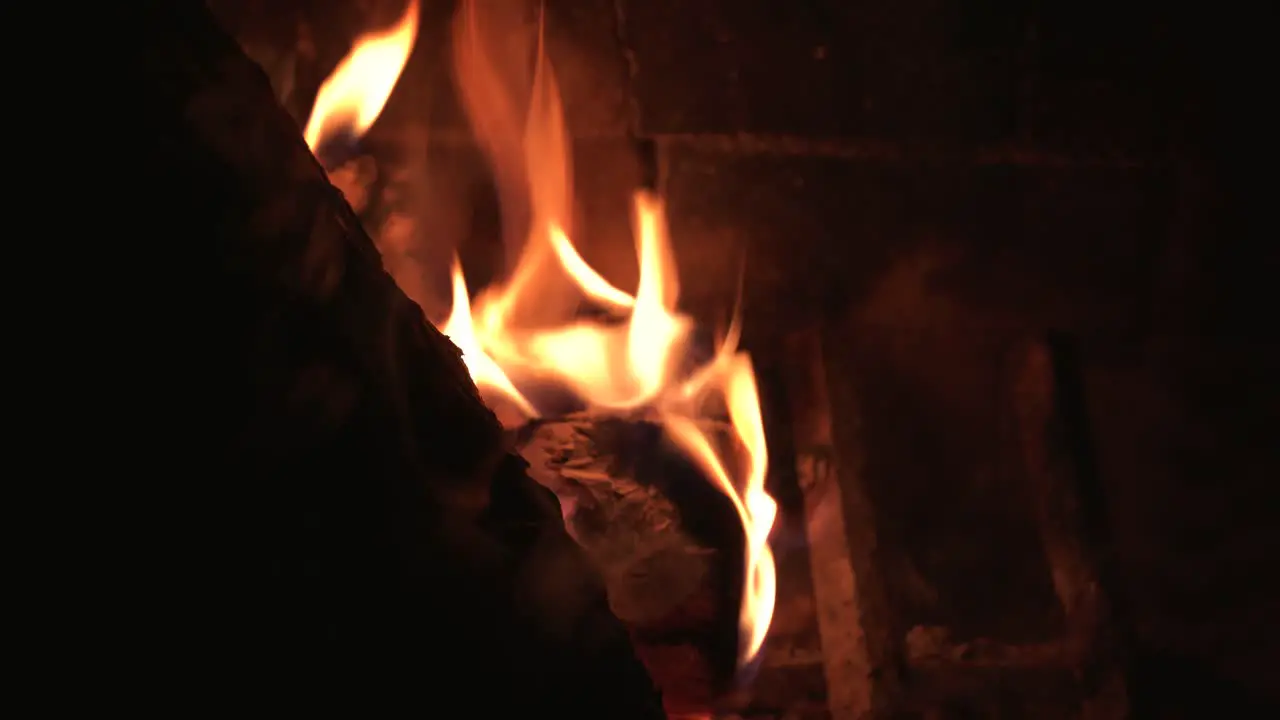 Close Up Flames Dancing in Front of Brick Background