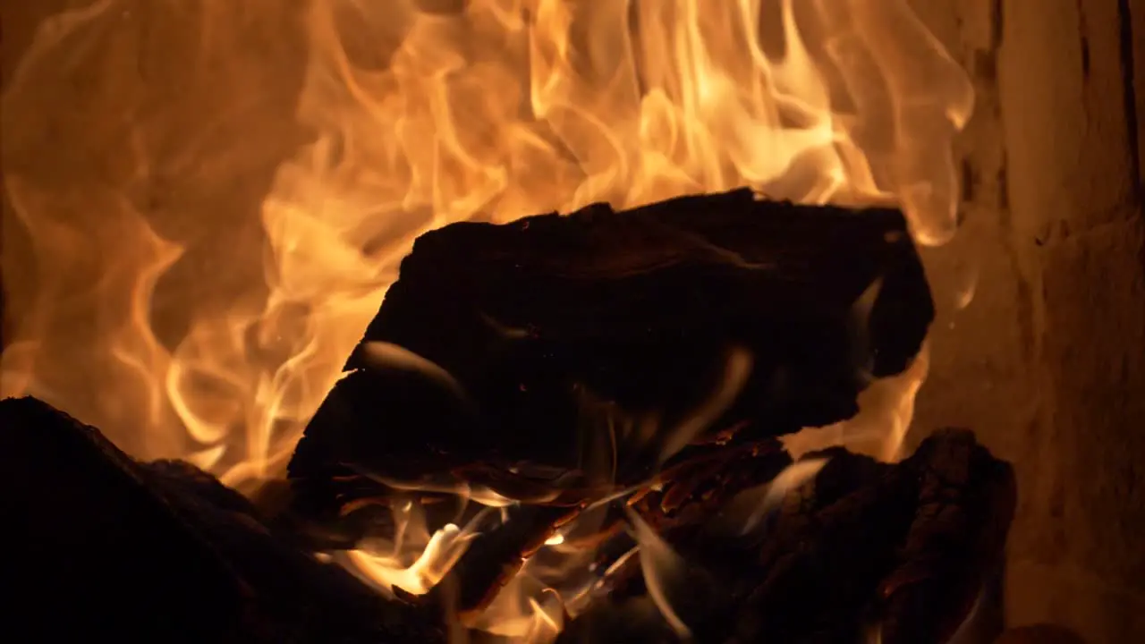 Firewood burning and exploding in a tile stove cockle 180 fps slow motion