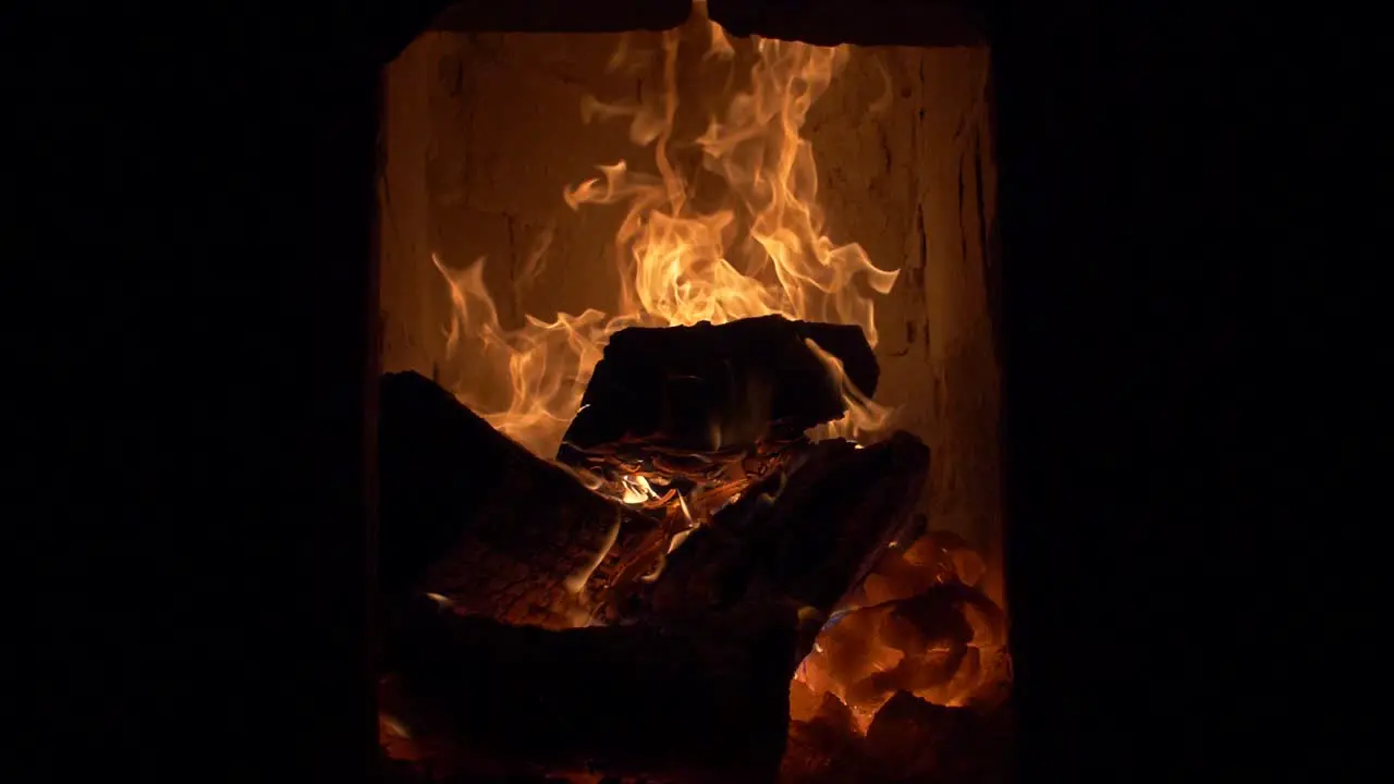 Firewood burning in tile stove cockle 180 fps slow motion