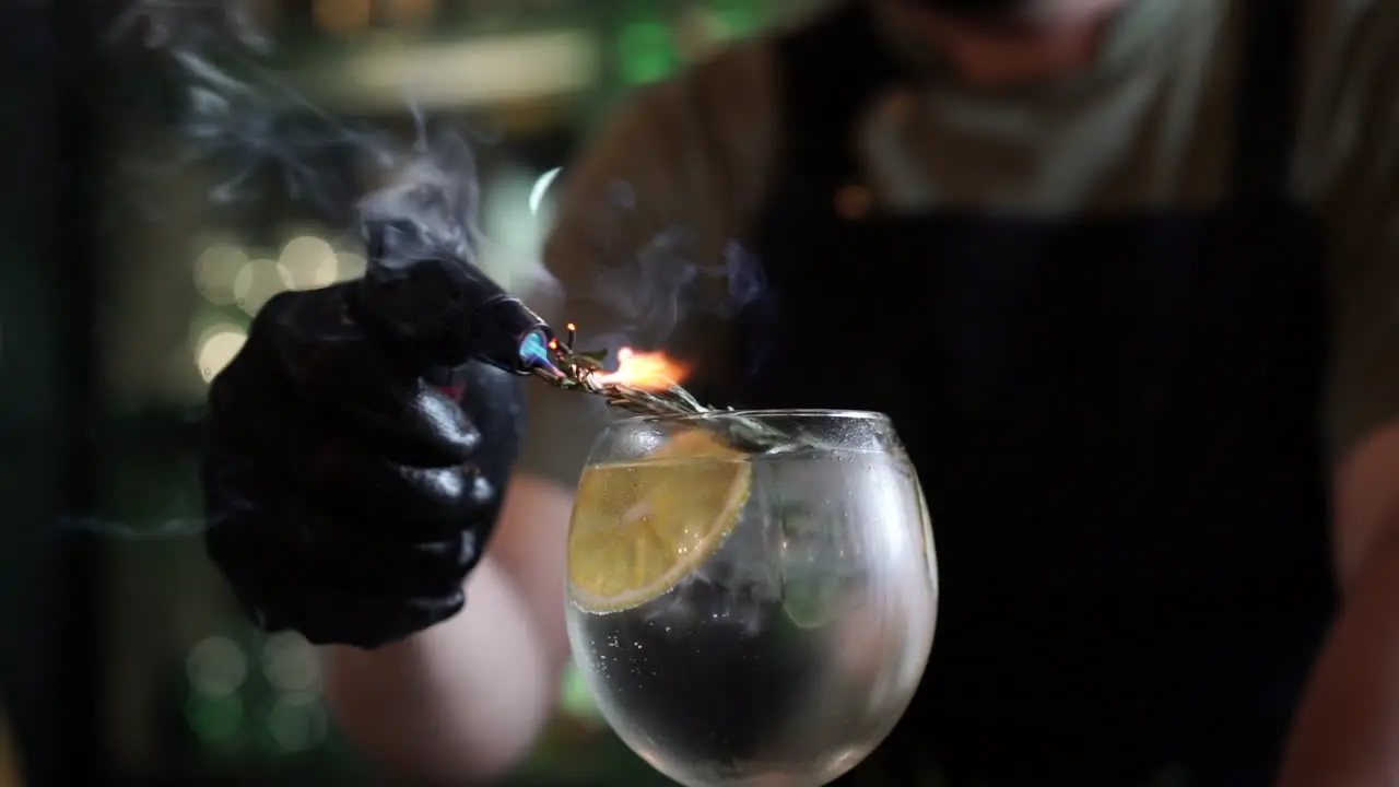 latin bartender flaming rosemary garnish tonic citric cocktail in slow motion