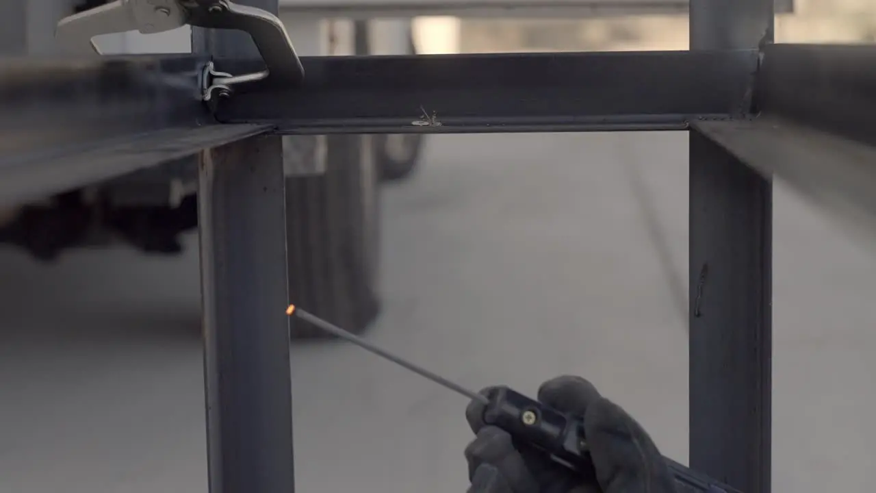 Slow Motion Of Worker Using Stick Welder To Weld Steel Framework