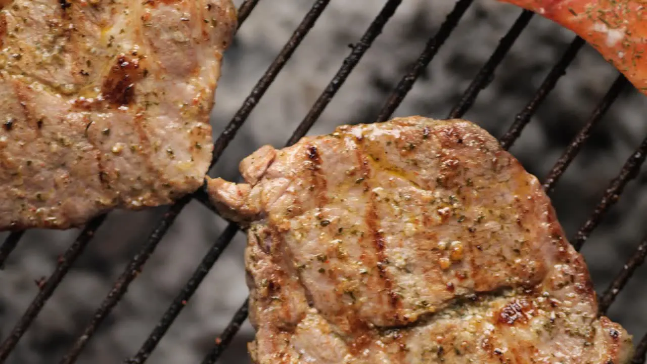 Top down shot of meat and vegetables lying on the smoky grill