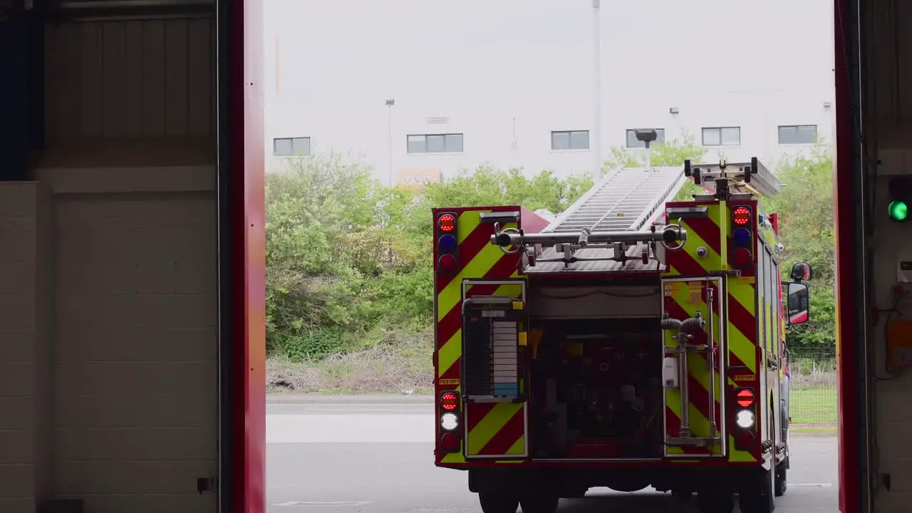 A red fire truck is seen reversing into the fire station after completion of checks by the crew