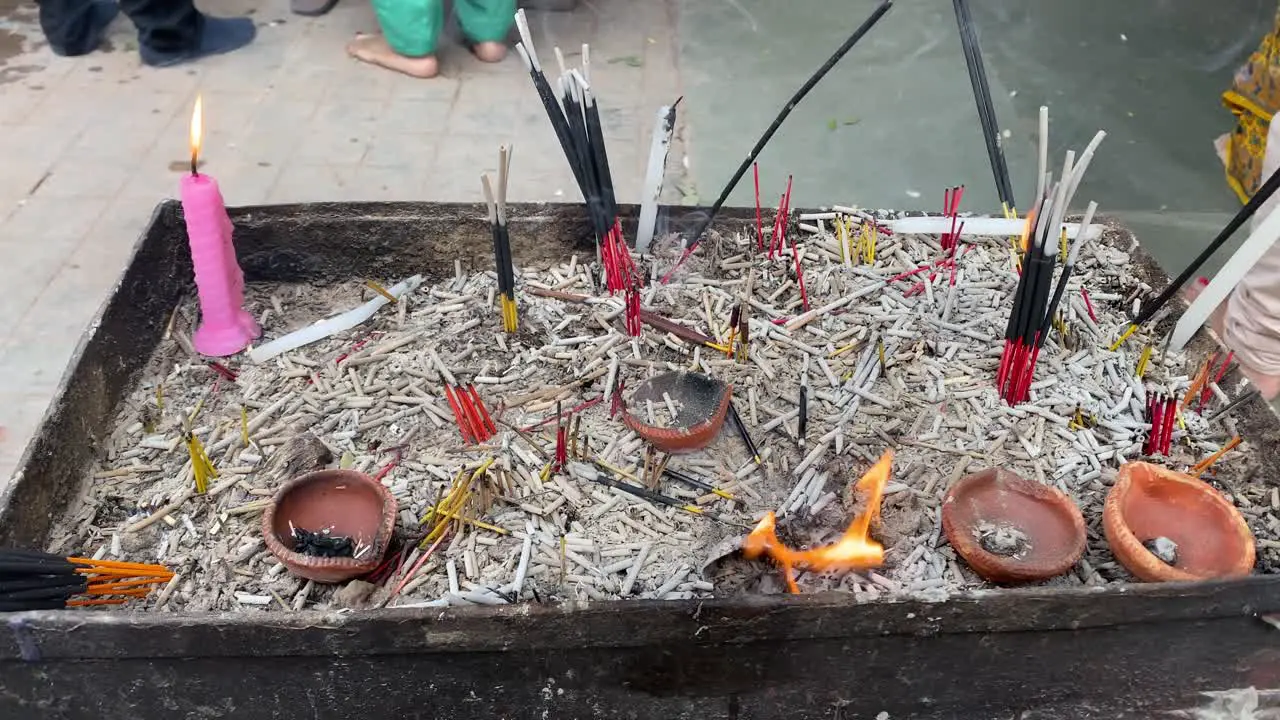 Remains of incense stick piles near a temple premise in India