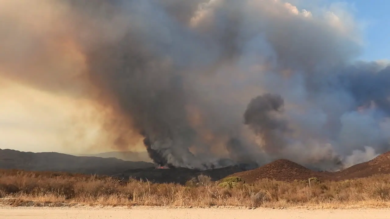 View of the Fairview Fire that is rapidly spreading across the hillside cloud of smoke in the burning area