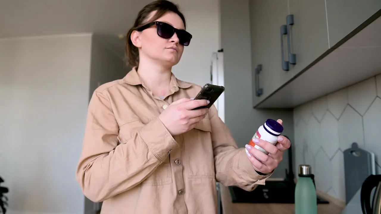 Blind Woman With Glasses Using Mobile App To Read Product Label At Home