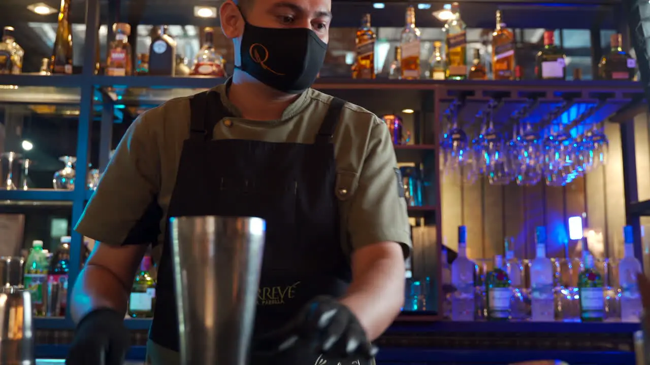 latin Bar tender mixing ingredients for cocktail preparation mixology