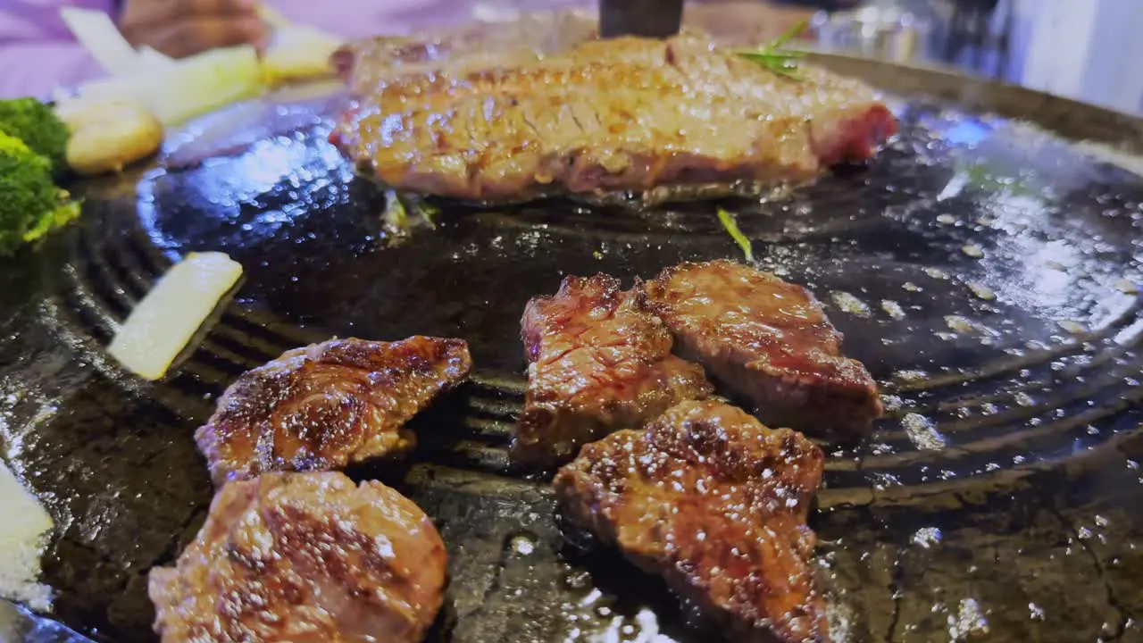 Close-up of cooking meat steak on traditional Korean bbq grill