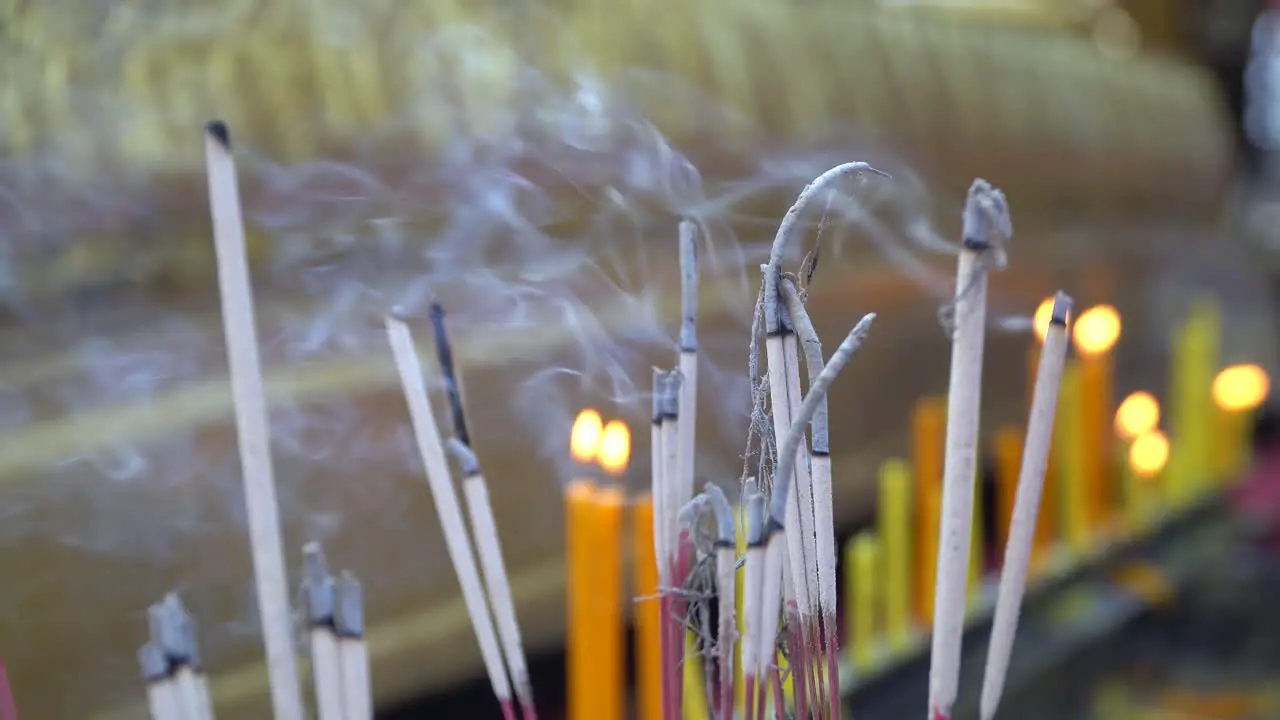 burning candles and incense in a temple in Chiang Mai Thailand