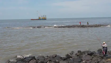 Close Up Of Waves Breaking On Bandra Fort In Mumbai India With People