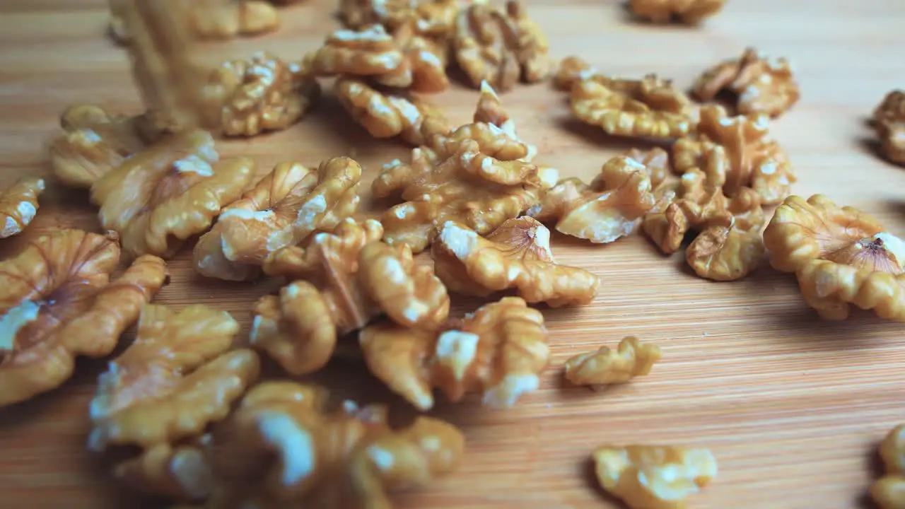 Walnuts falling on a wooden cutting board