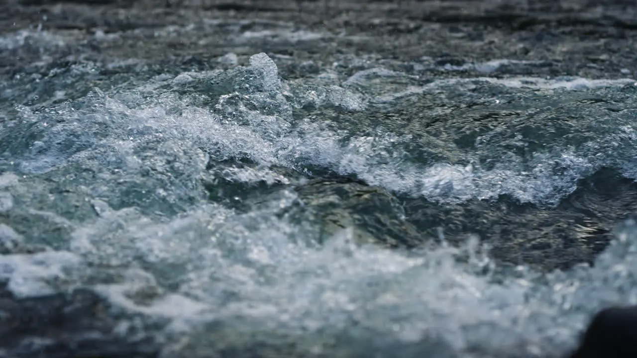 Mountain river water flowing in slow motion Powerful stream in mountain river