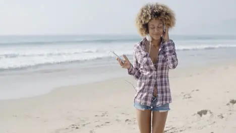 Young Woman Listening To Music At The Beach