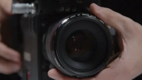 Close Up Shot of Person Adjusting Focus On Lens and Using Touchscreen Monitor