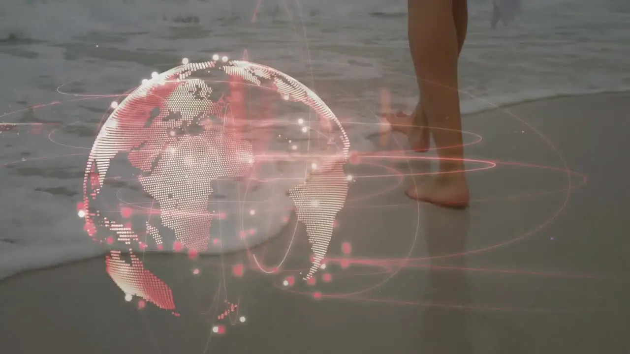 Light trails over spinning globe against low section of a woman walking at the beach