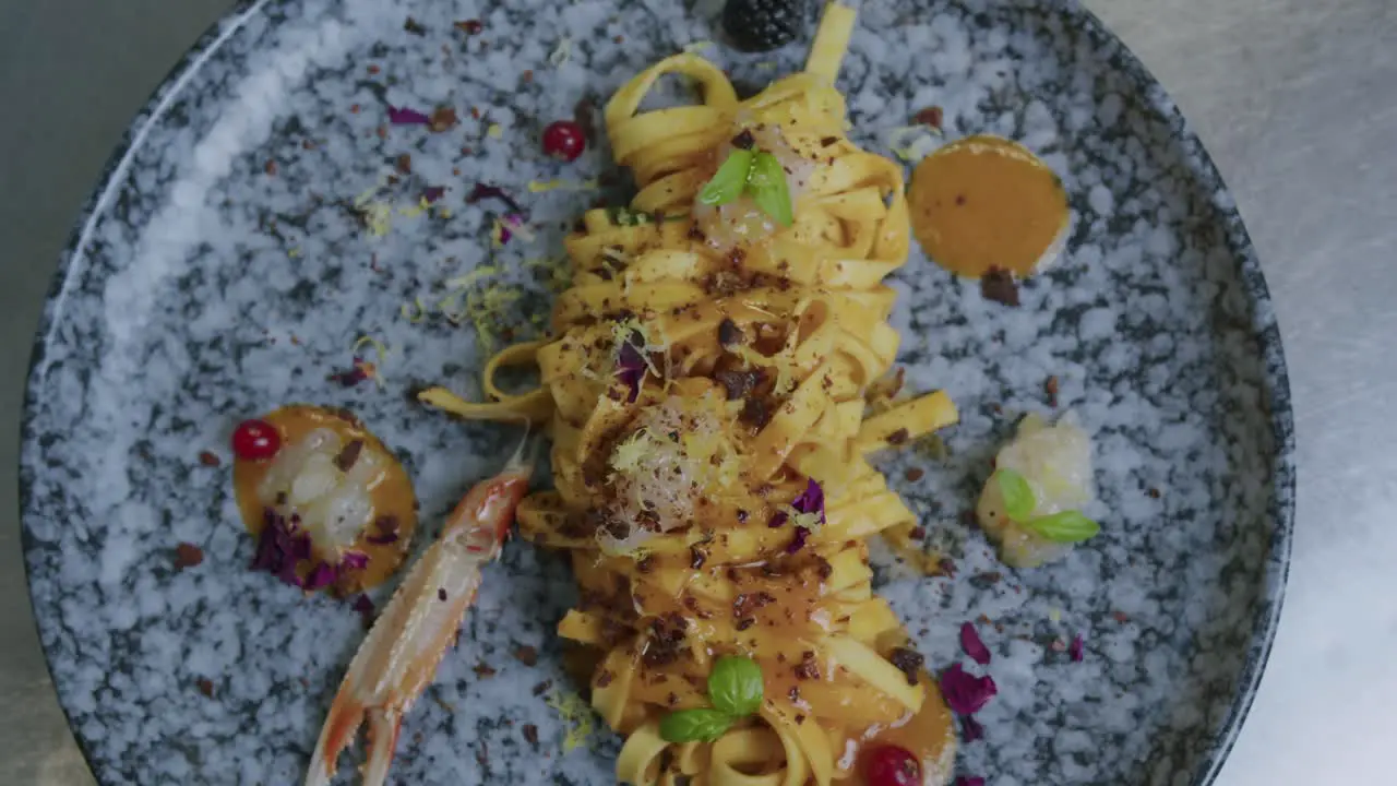 Close up shot of a plate full of pasta and scampi made from a professional chef in Italy 02