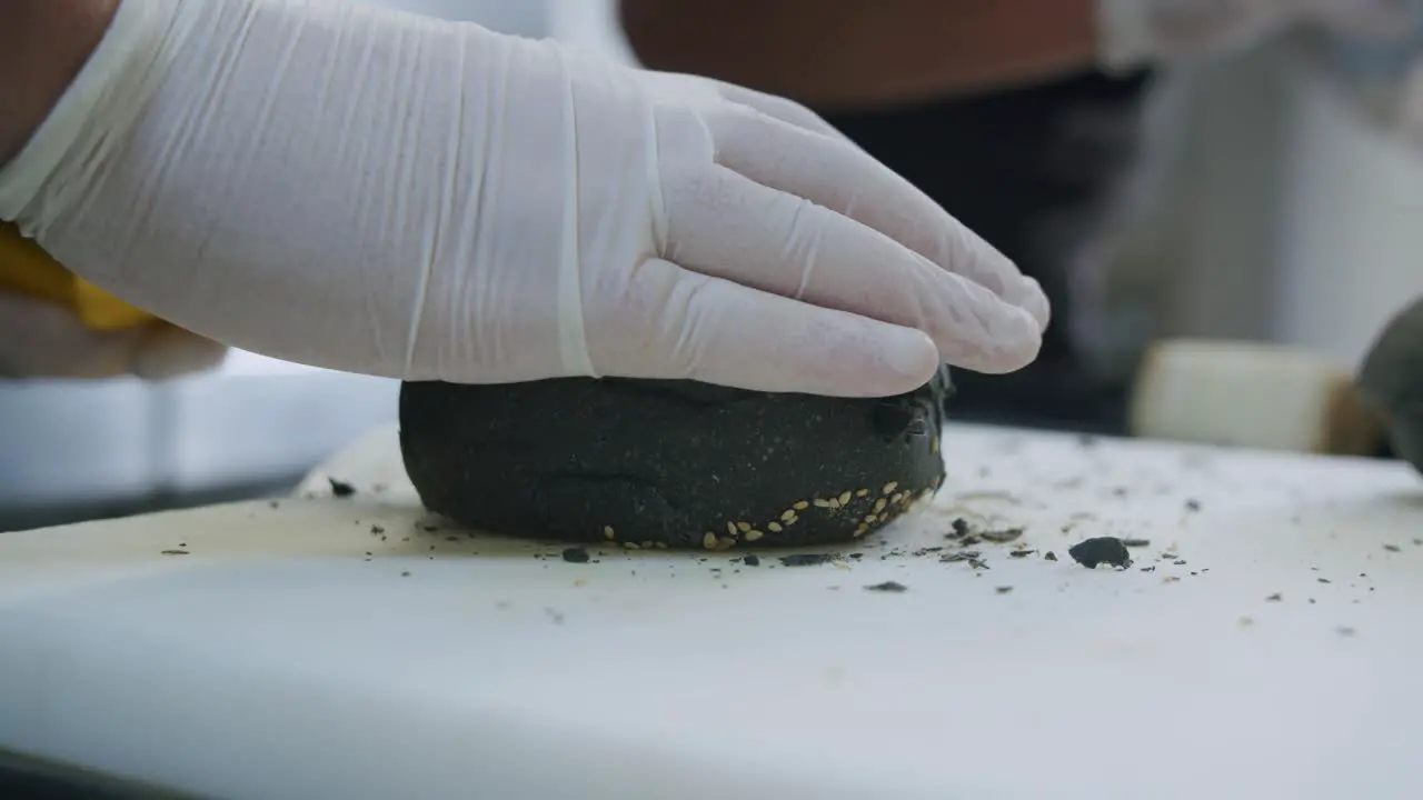 A professional chef is preparing a hamburger in his kitchen 03