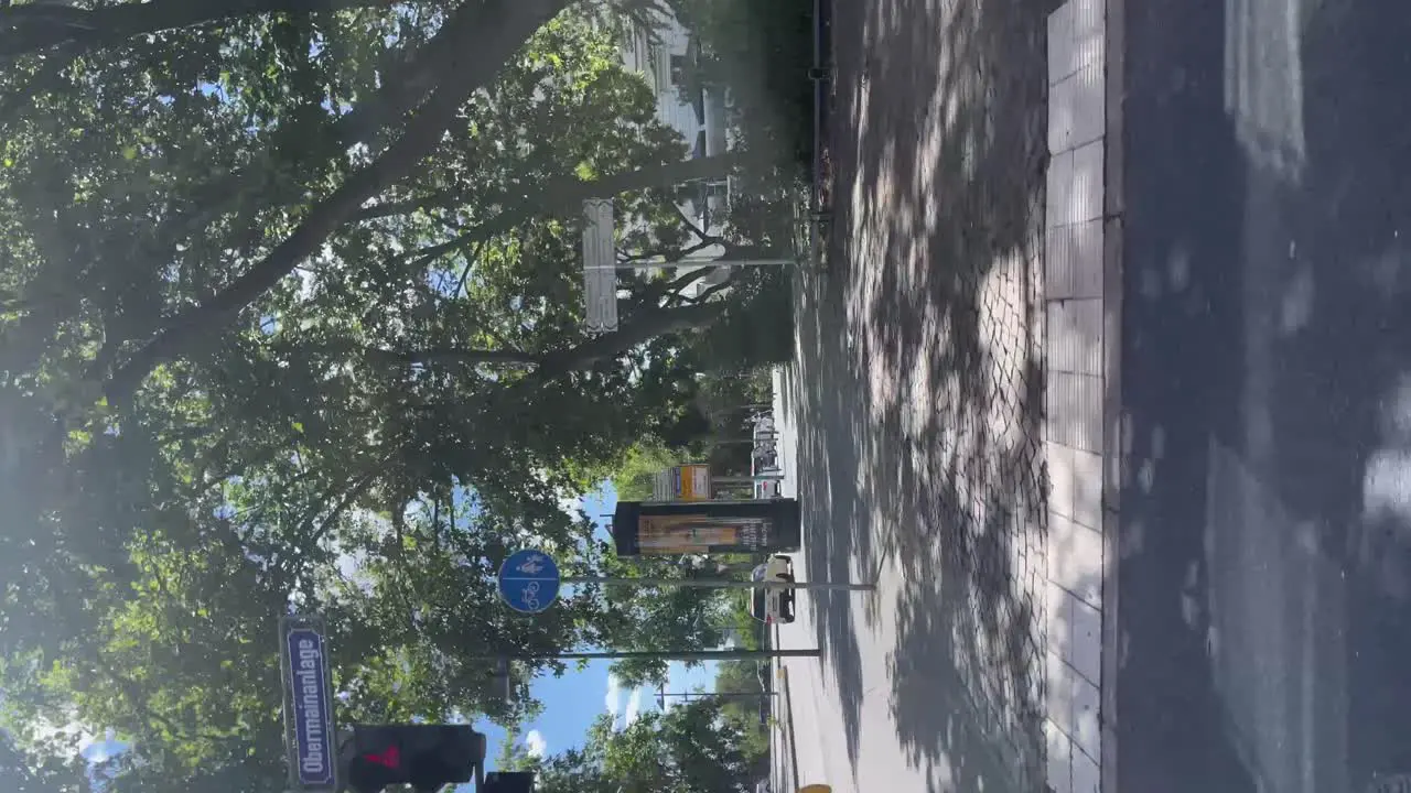 POV Looking Out Window Driving Past Urban Street In Frankfurt On Sunny Day