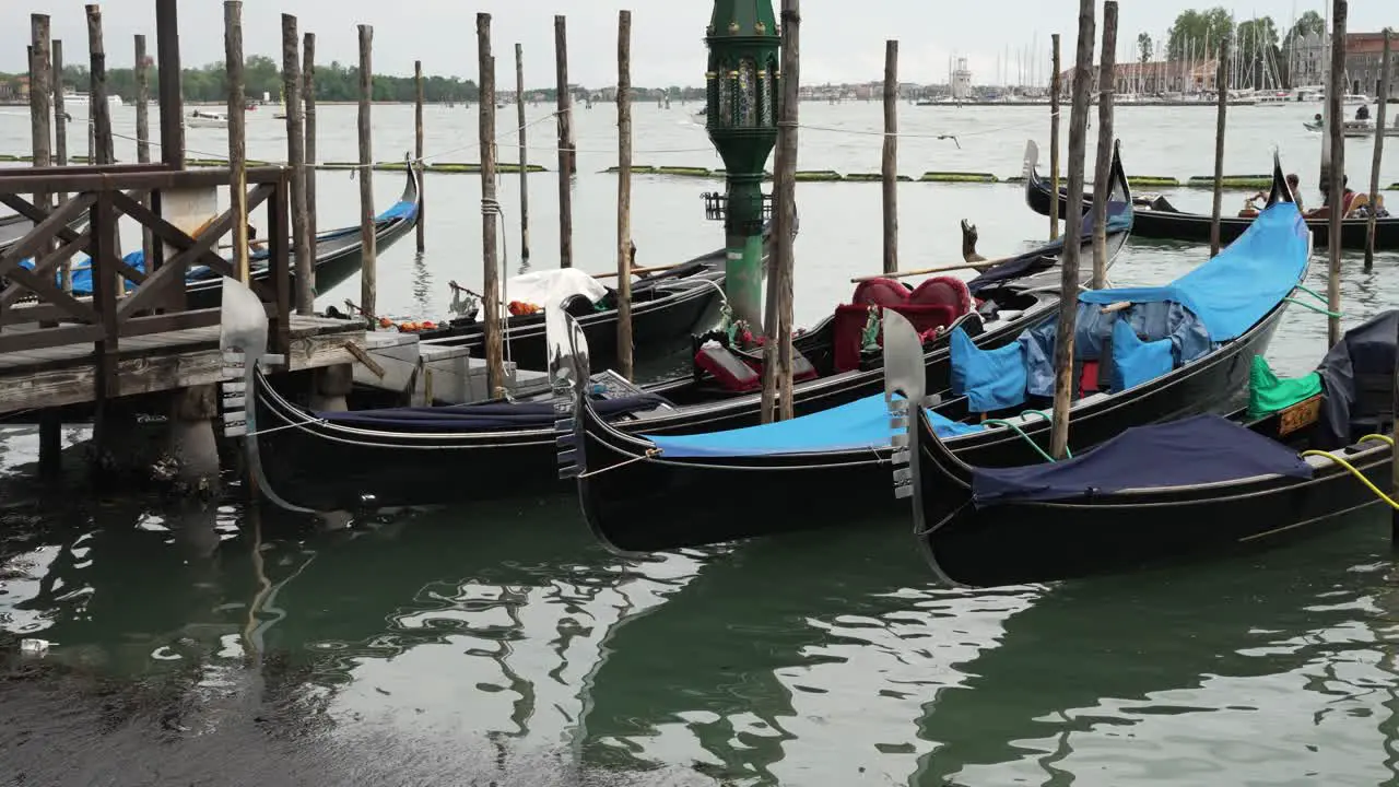 Rows Of Empty Traditional Gondolas Moored Beside The Grand Canal In Venice