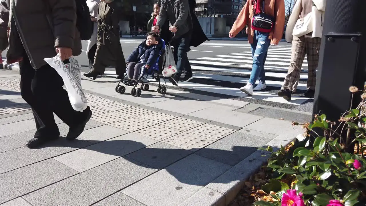 4k HD video while walking cross the street over zebra line in slowmotion in Tokyo in slow motion