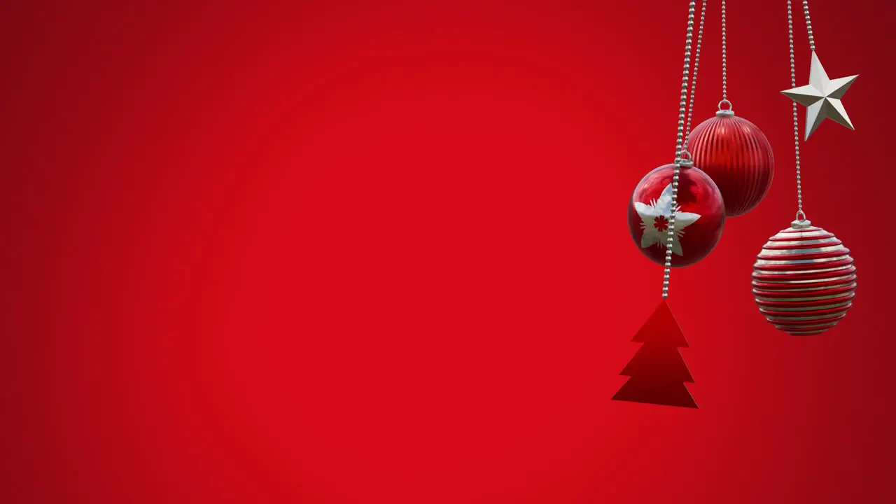 Animation of hanging baubles tree and star swinging against red background