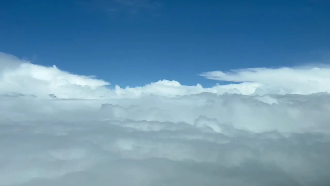 Nice aerial jet cockpit view of a messy sky plenty of stormy clouds avoiding bad weather ahead