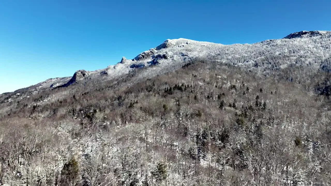 aerial slow creep into grandfather mountain nc in winter