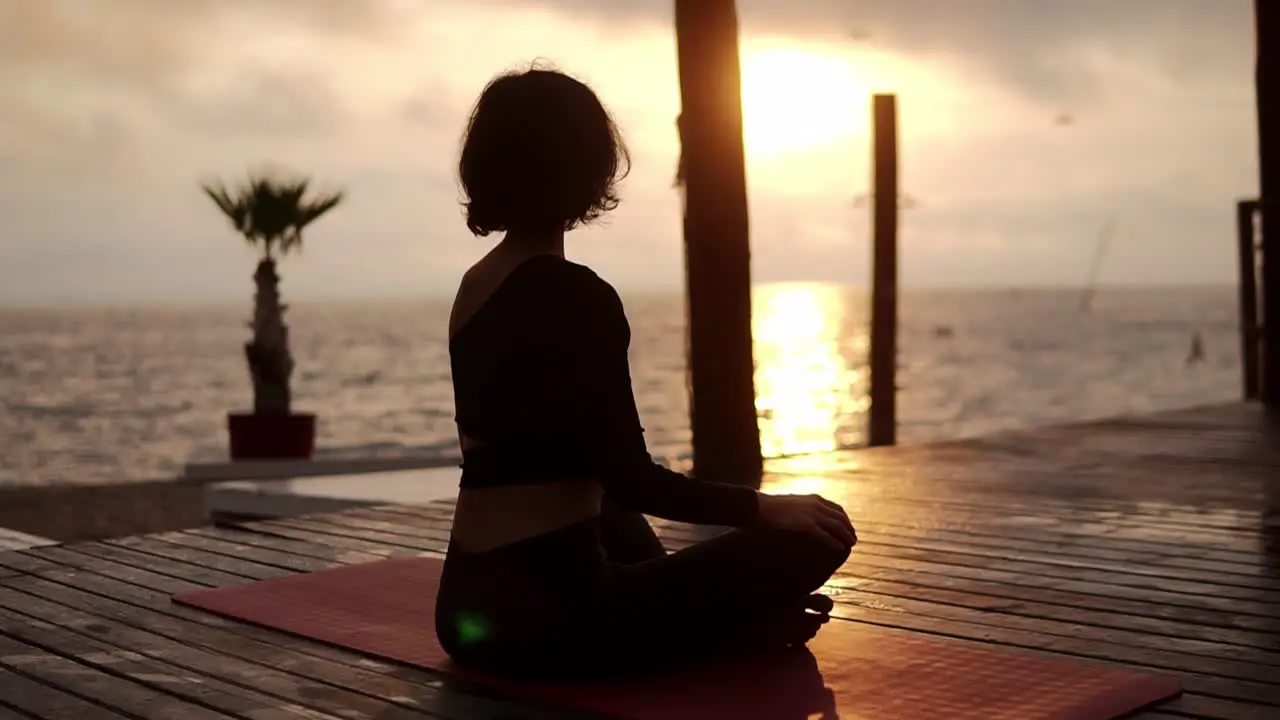 Yogi Girl Is Sitting In Lotus Pose In Front The Sea In Summer On Sunset Healthy Lifestyle Movement Concept Meditation Concept