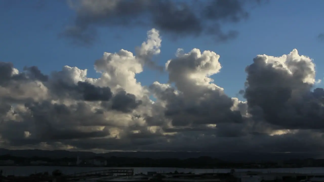 Cumulus clouds rise into a blue sky