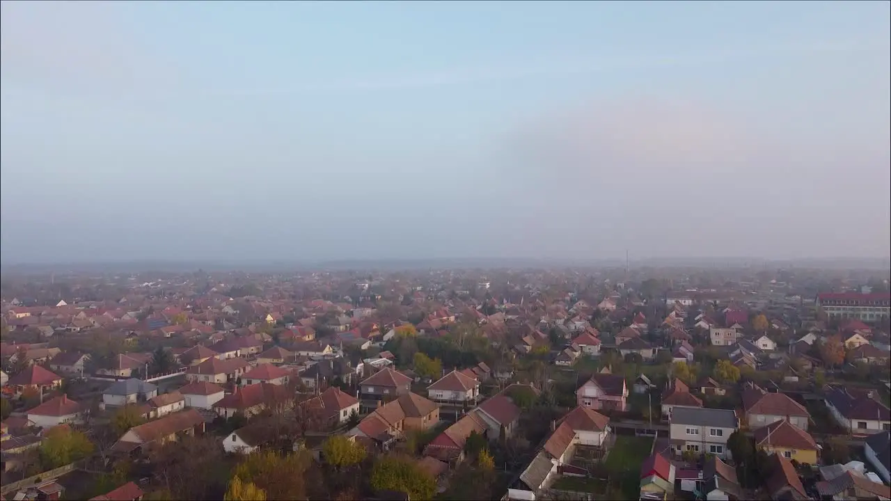 Drone flying over foggy town