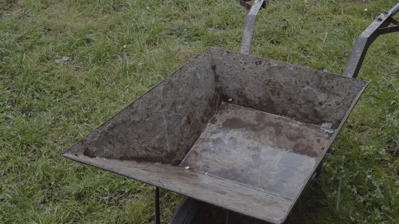 Old Rusty Steel Wheelbarrow in The Rain 4K