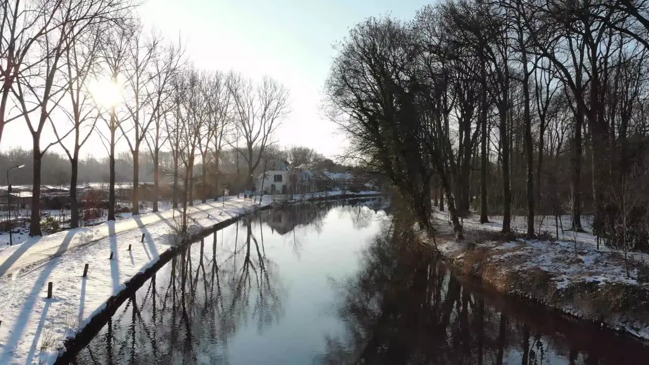 Droneshot in of the river Vecht in Utrecht during sunrise in winter time with snow