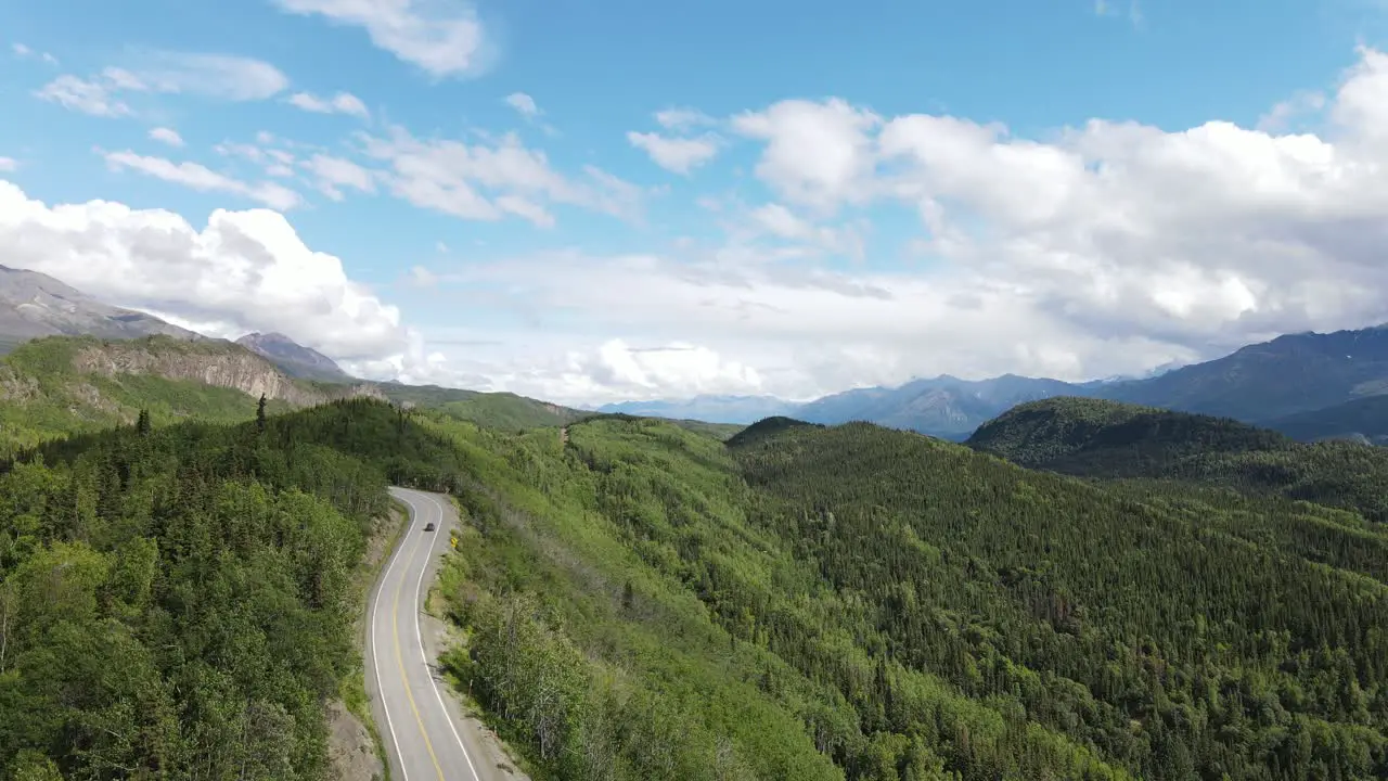 rural highway in lush green mountains aerial