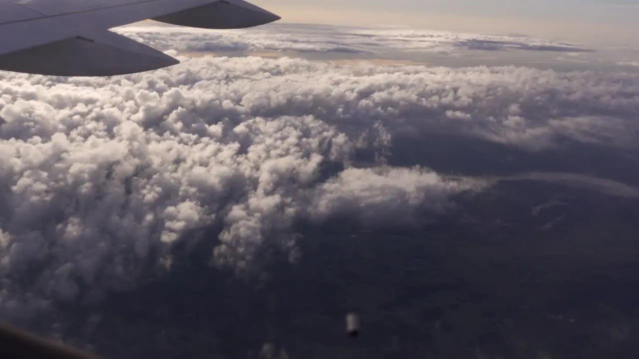 View of Fluffy Clouds from an Airplane Window