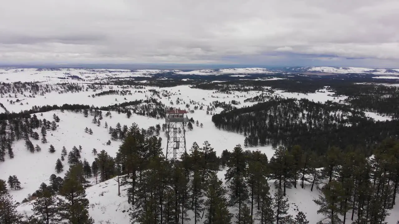 Wilderness Firetower on top of a mountain in the snow Aerial