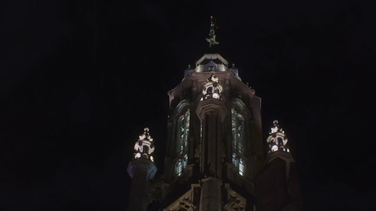 rain and thunder with lighting and spire tower traditional architecture european building in the night