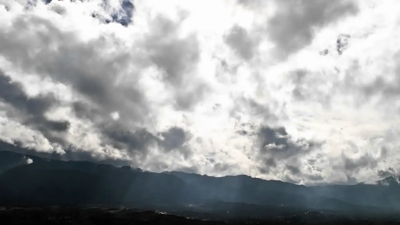 Time lapse of clouds passing dramatically over a valley