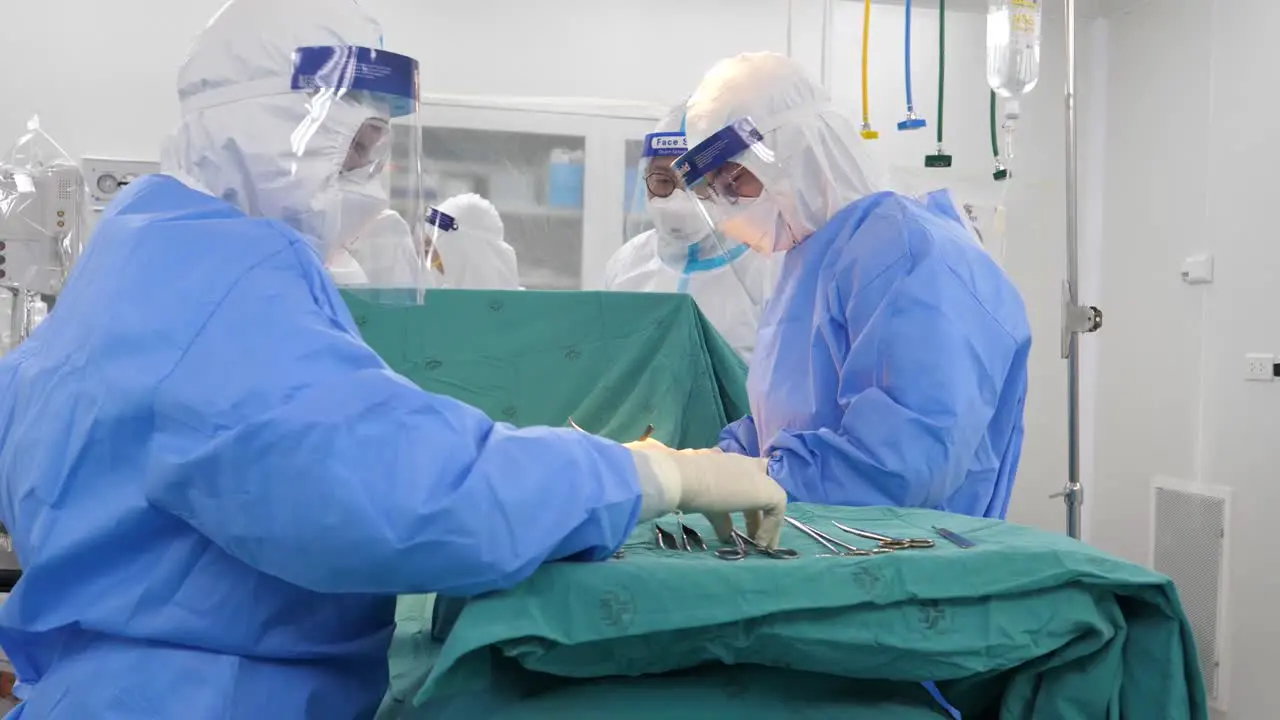 Asian Doctor Wear Infection Control Gown Perform Surgery In Operating Room