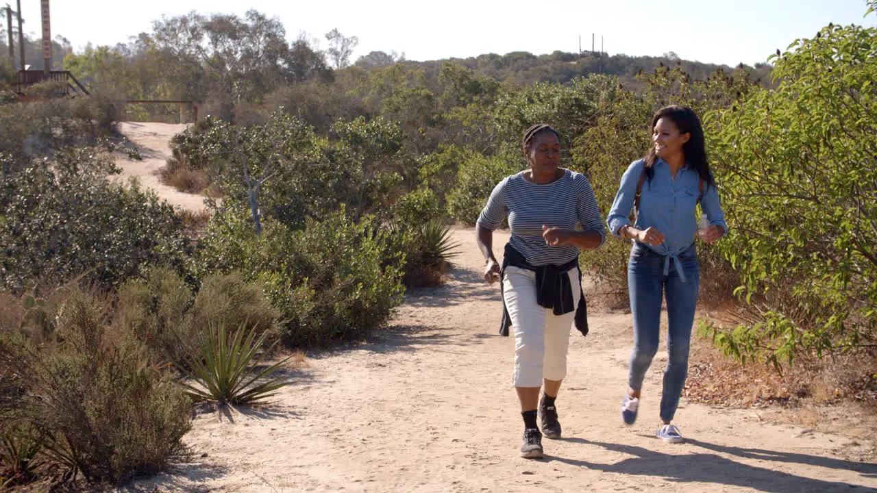 African American mother hiking with her adult daughter