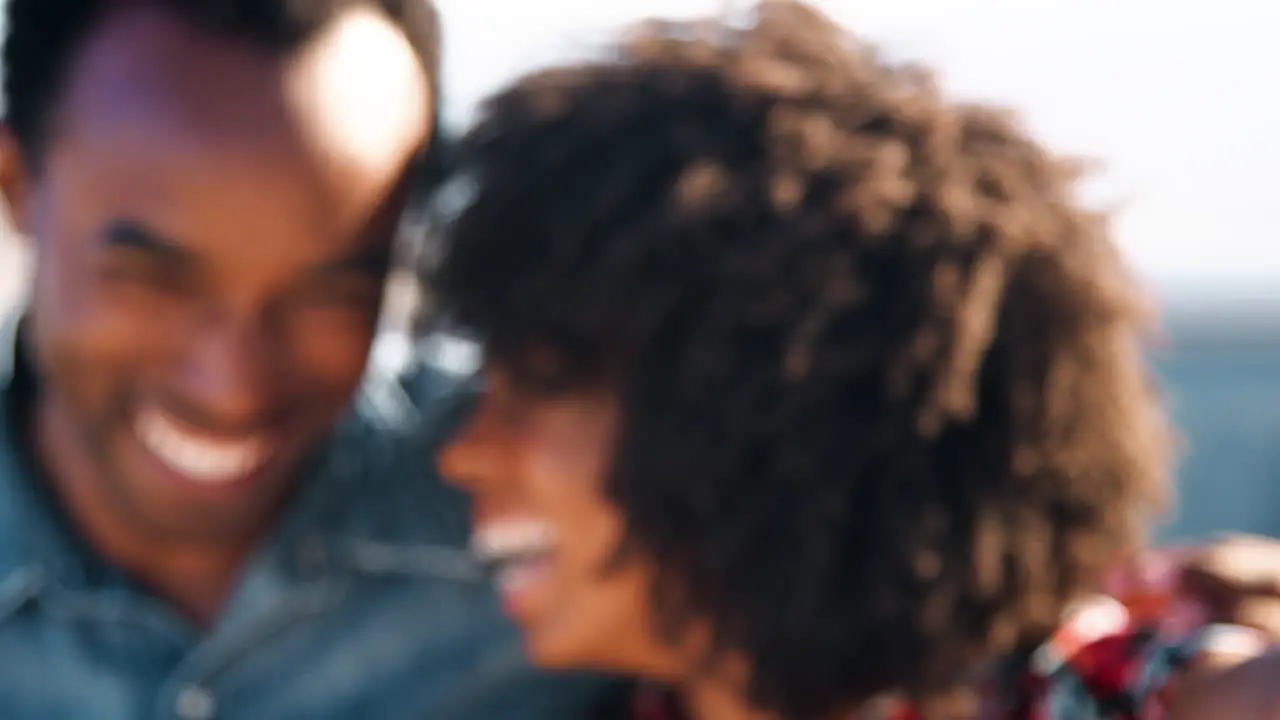 Young black couple at roadside holding car keys close up