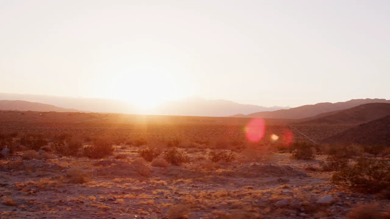 Desert landscape at sunset seen from moving vehicle