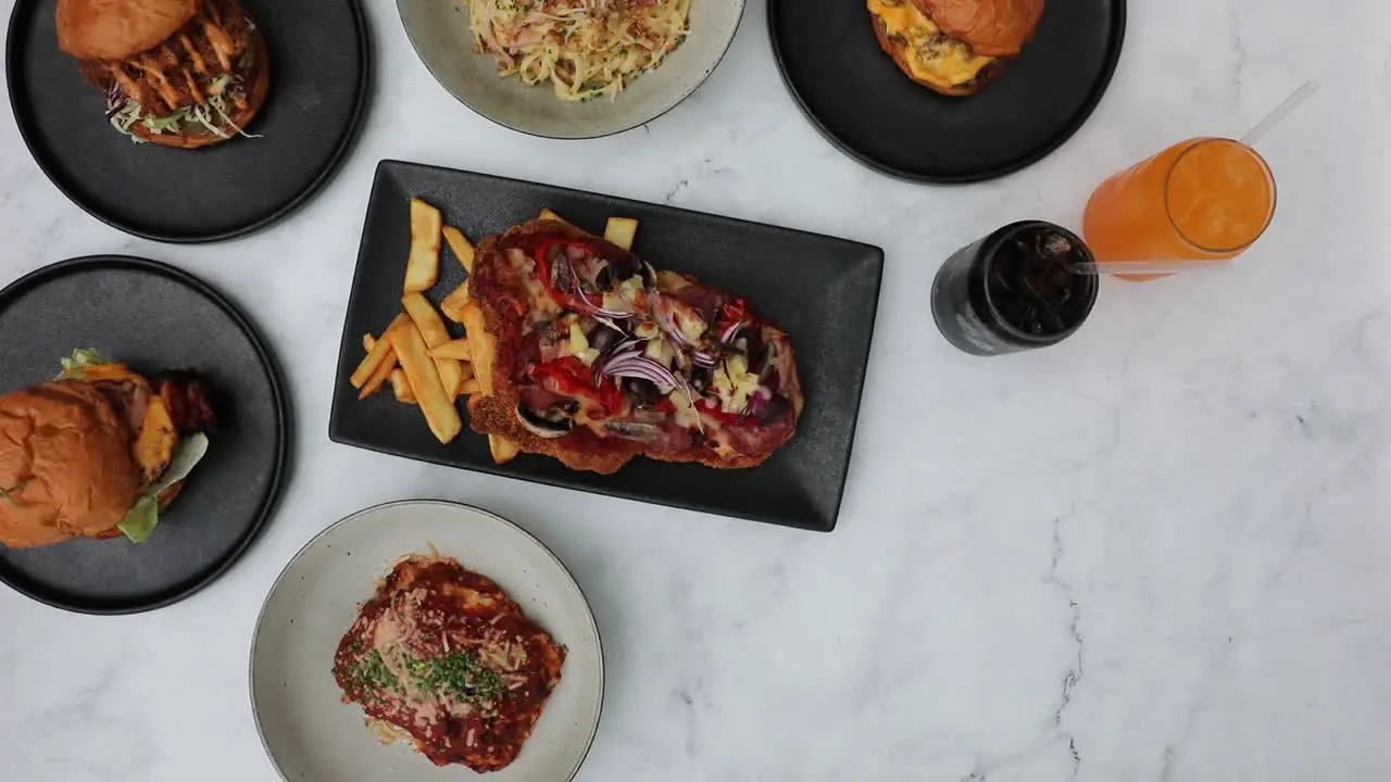 Male hands putting down delicious bowl of hot wedges onto table setting