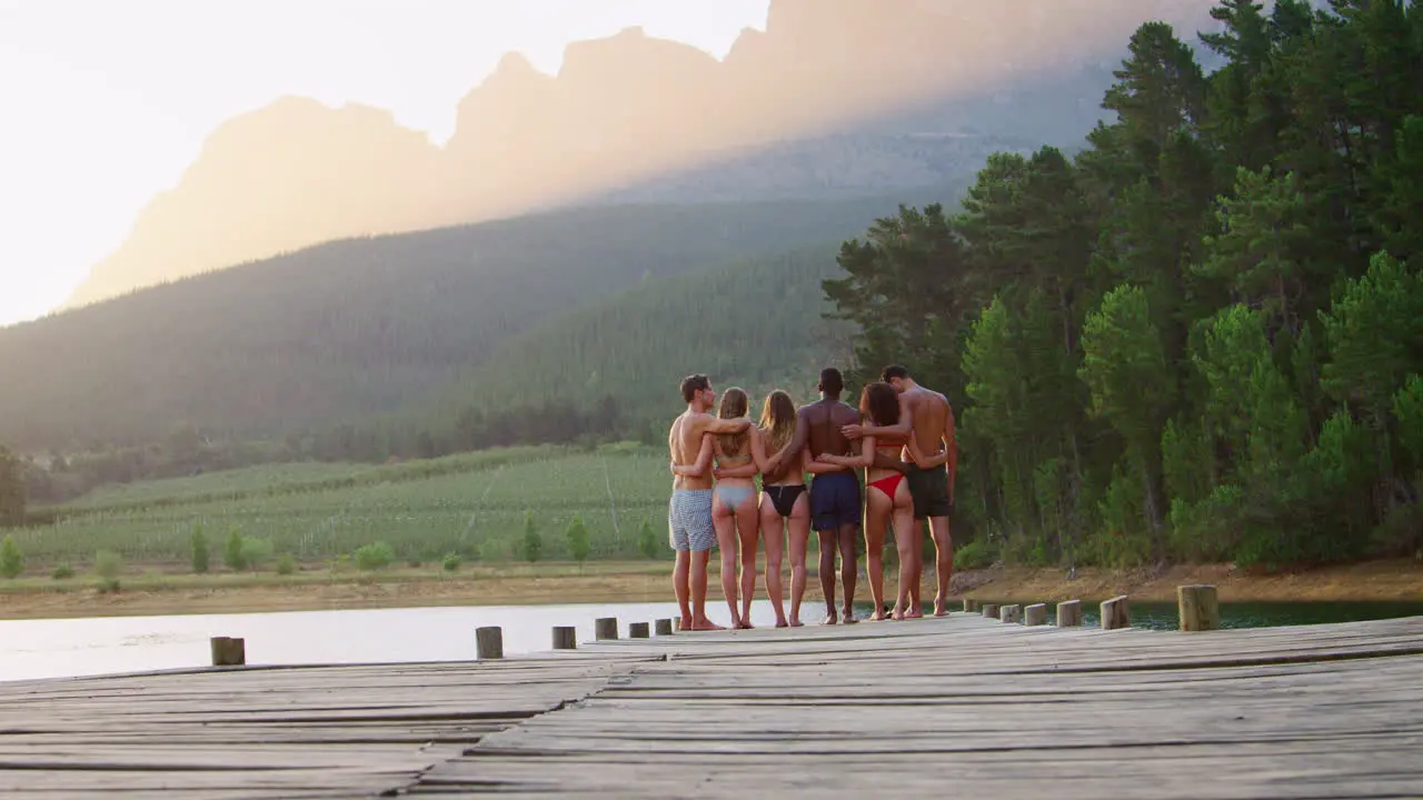 Group of friends admiring view from jetty back view