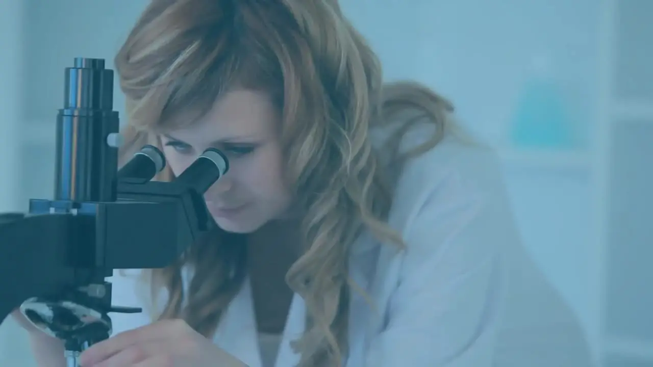 Female scientist using microscope with floating molecules