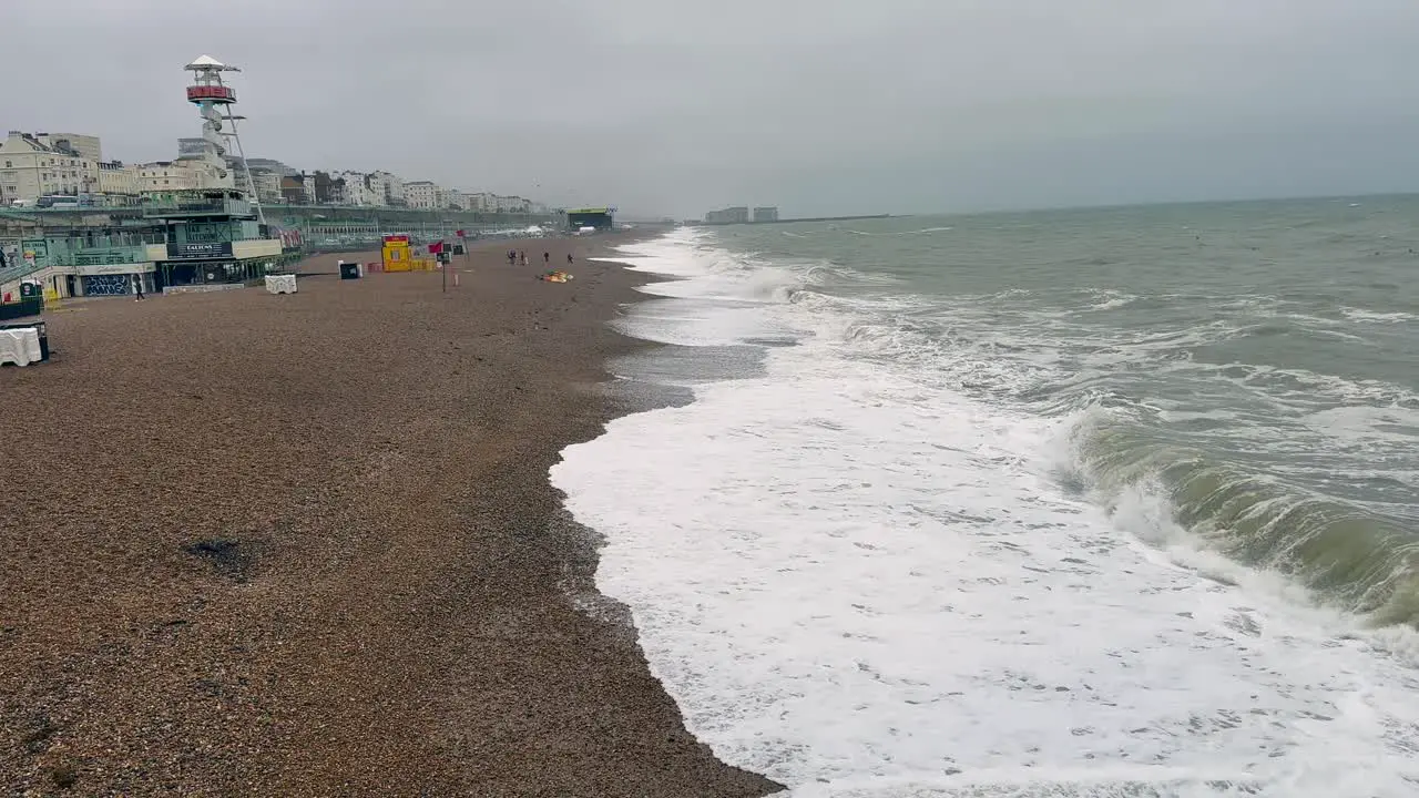 Capturing the raw elements on an overcast day this footage scans Brighton beach where high winds whip up crashing waves