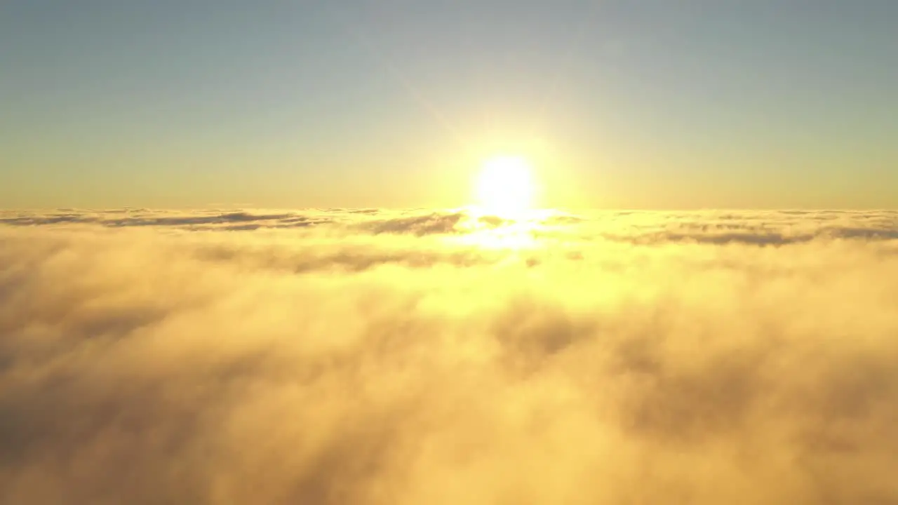 Drone aerial view of moving clouds and sun over horizon