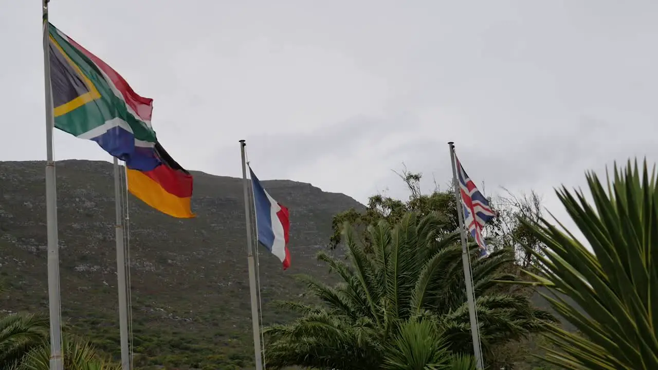 Flags of South Africa Germany France and Great Britain flapping in strong winds at Cape Point South Africa