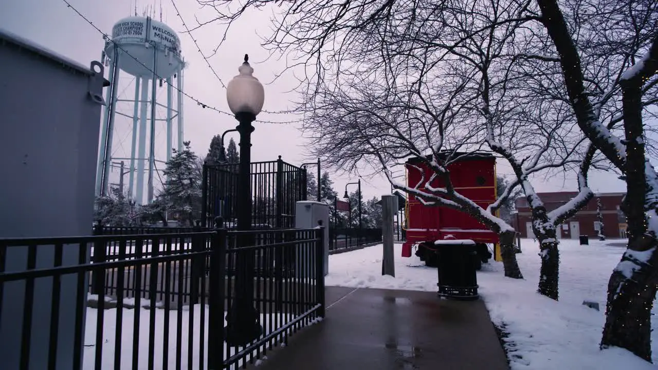 Snow day on walkway to train station near water tower